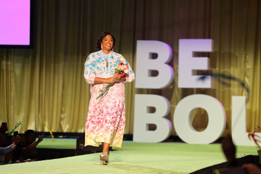 A woman walking the runway in a House of Perna floral print maxi dress