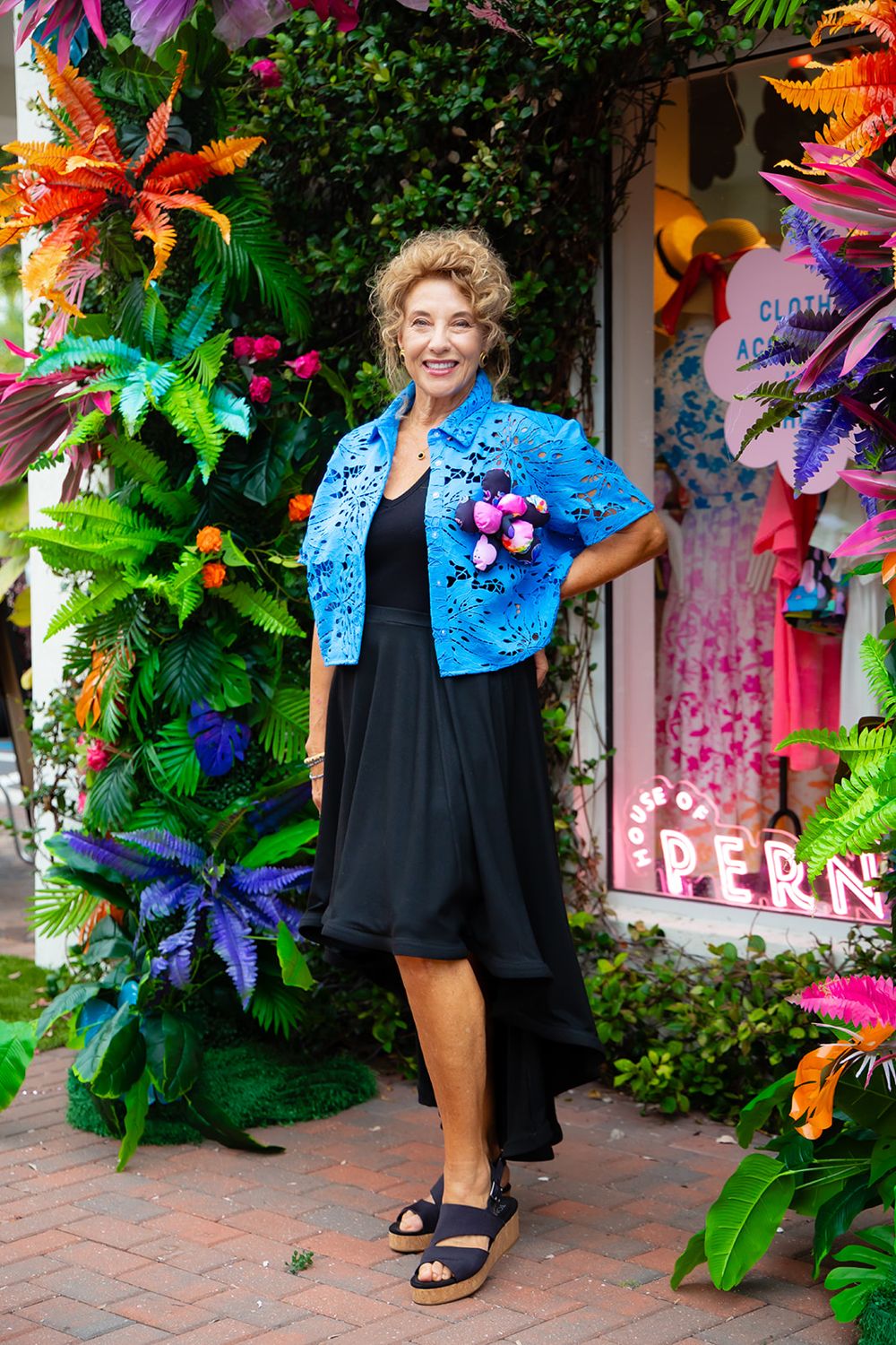 Rita in a blue cutout cropped shirt and black skirt