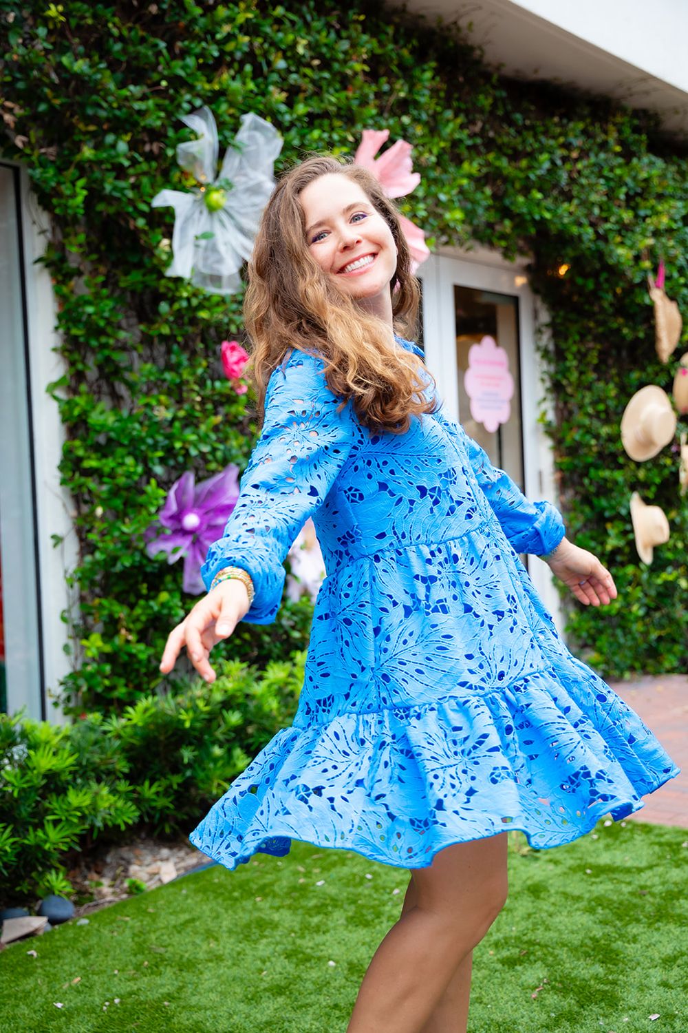 Rachel in a blue eyelet tiered mini dress