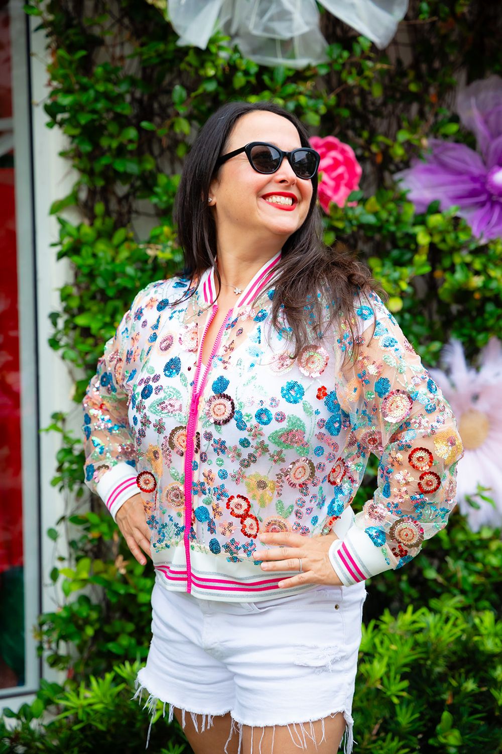 Jill in a sequin floral bomber jacket